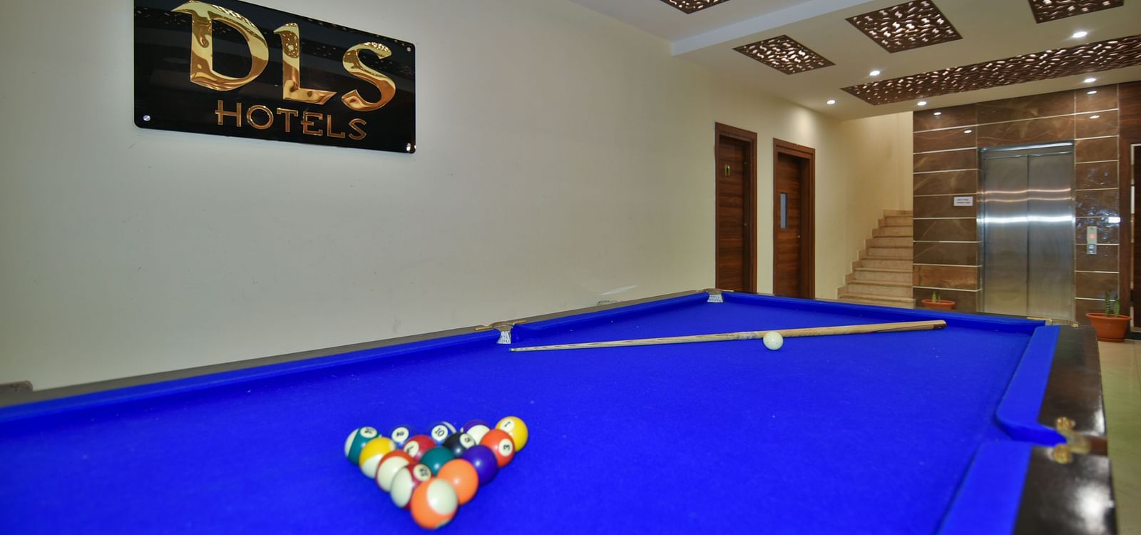 A pool table with billiard balls placed on the table at DLS Highland Resort and Spa, Mussoorie.